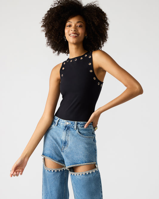 A woman is wearing a black sleeveless bodysuit with silver button details on the neckline.