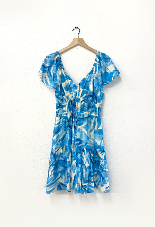A blue and white dress hanging from a hanger.